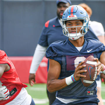 Quarterback Austin Simmons (8) throws a pass at Ole Miss football practice in Oxford, Miss., on Friday, Aug. 11, 2023.