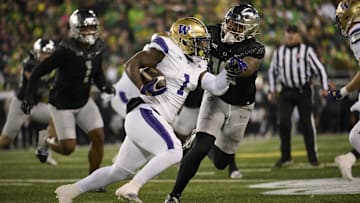 Nov 30, 2024; Eugene, Oregon, USA; Washington Huskies running back Jonah Coleman (1) carries the ball during the first half against Oregon Ducks defensive end Matayo Uiagalelei (10) at Autzen Stadium. Mandatory Credit: Troy Wayrynen-Imagn Images