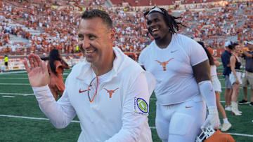 Texas Longhorns head coach Steve Sarkisian and Texas Longhorns defensive lineman T'Vondre Sweat smile as they walk off the field after beating the Kansas Jayhawks at Royal-Memorial Stadium on Saturday September 30, 2023.