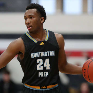 Huntington Prep guard Darryn Peterson takes the ball up the court during the first half at Canton Memorial Field House, Saturday, Feb. 17, 2024.