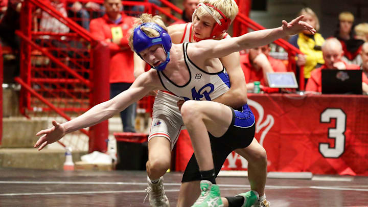 Mineral Point’s Liam Carey (blue headgear) spreads his arms out as he wrestles Weyauwega-Fremont’s Rylan Konen in a 120-pound match at the WIAA State Team Wrestling Tournament on March 8, 2025. Mineral Point’s Liam Carey (blue headgear) spreads his arms out as he wrestles Weyauwega-Fremont’s Rylan Konen in a 120-pound match at the WIAA State Team Wrestling Tournament on March 8, 2025.