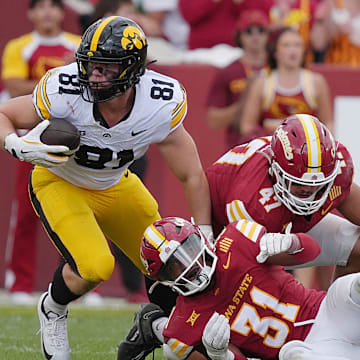 Iowa Hawkeyes tight end DJ Vonnahme (81) makes a catch around Iowa State Cyclones' defensive back Marcus Neal Jr.(31) and linebacker Kooper Ebel (47) during the fourth quarter in the Cy-Hawk football at Jack Trice Stadium on Sept. 6, 2025, in Ames, Iowa