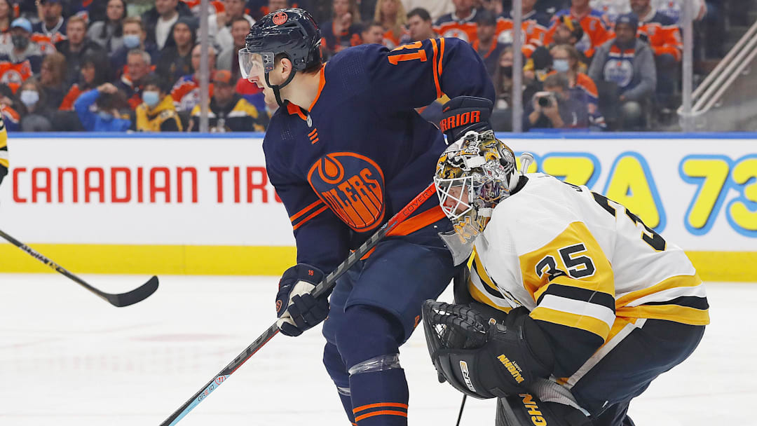 Dec 1, 2021; Edmonton, Alberta, CAN; Edmonton Oilers forward Zach Hyman (18) tries to screen Pittsburgh Penguins goaltender Tristan Jarry (35) during the first period at Rogers Place. Mandatory Credit: Perry Nelson-Imagn Images