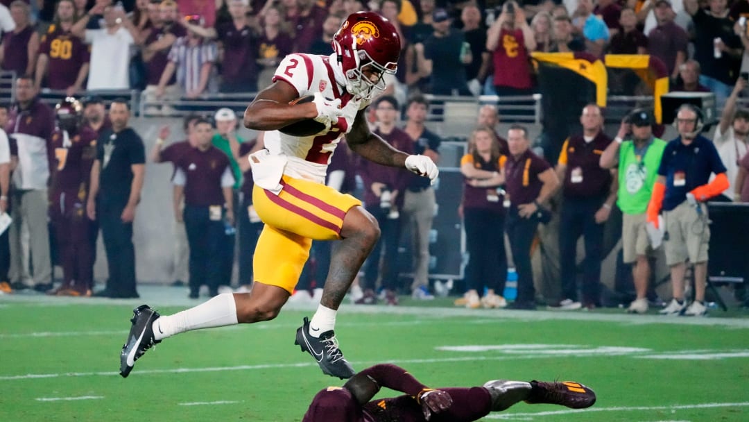 USC Trojans wide receiver Brenden Rice (2) jumps over Arizona State Sun Devils defensive back Demetries Ford (4) to score a touchdown in the first half at Mountain America Stadium on Sept. 23, 2023. USC Trojans wide receiver Brenden Rice (2) jumps over Arizona State Sun Devils defensive back Demetries Ford (4) to score a touchdown in the first half at Mountain America Stadium on Sept. 23, 2023.