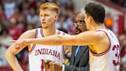 Indiana's Luke Goode (10) and Trey Galloway (32) talk with Coach Mike Woodson during the Indiana versus Purdue mens basketball game at Simon Skjodt Assembly Hall on Sunday, Feb. 23, 2025.
