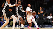 Oct 8, 2025; Miami, Florida, USA;  Miami Heat guard Norman Powell (24) drives to the basket as San Antonio Spurs guard/forward Devin Vassell (24) defends during the first half at Kaseya Center. Mandatory Credit: Jim Rassol-Imagn Images