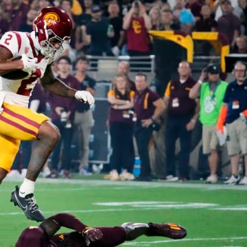 USC Trojans wide receiver Brenden Rice (2) jumps over Arizona State Sun Devils defensive back Demetries Ford (4) to score a touchdown in the first half at Mountain America Stadium on Sept. 23, 2023.