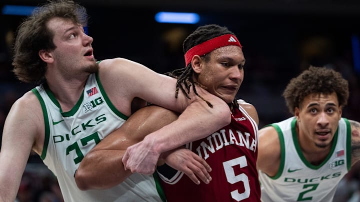Indiana Hoosiers forward Malik Reneau (5) and Oregon Ducks center Nate Bittle (32) fight for position Thursday, March 13, 2025, during a free throw during the 2025 TIAA Big Ten Men’s Basketball Tournament at Gainbridge Fieldhouse in Indianapolis.