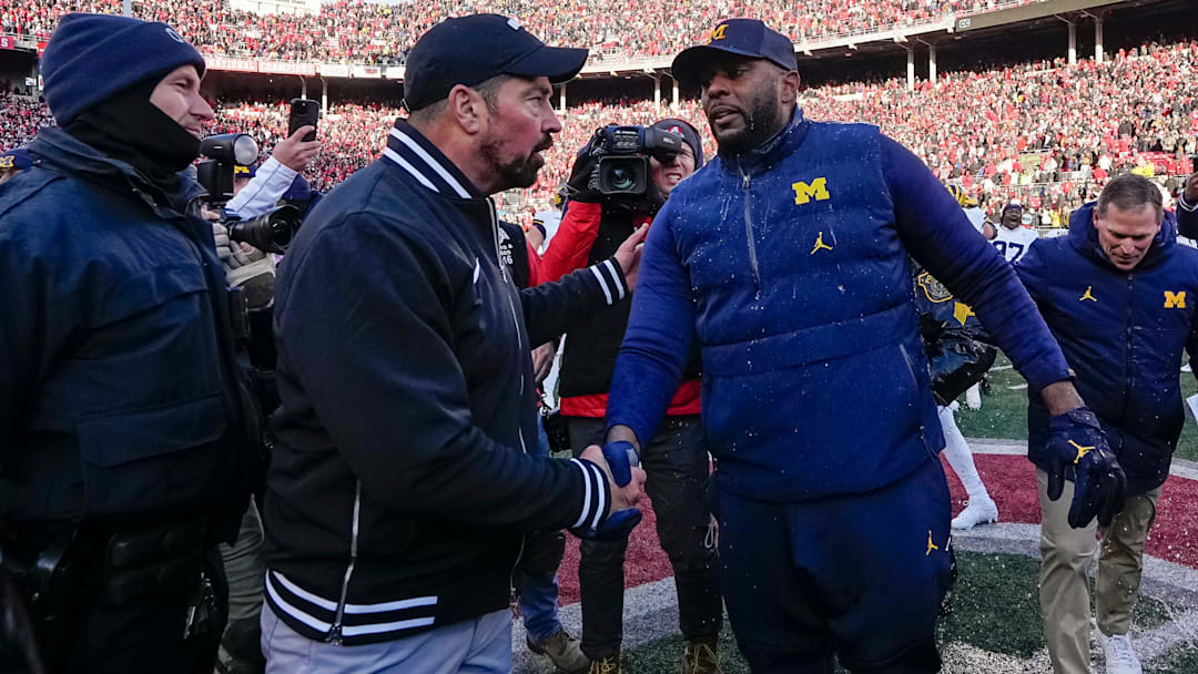 Ohio State Buckeyes head coach Ryan Day shakes hands with Michigan Wolverines head coach Sherrone Moore following Michigan's 13-10 victory. Ohio State Buckeyes head coach Ryan Day shakes hands with Michigan Wolverines head coach Sherrone Moore following Michigan's 13-10 victory.