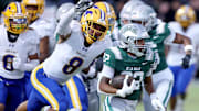 Running back Derrick Blanche (right) of De La Salle attempts to elude Grant linebacker Jeremiah Tuiileila, who had a game-high nine tackles in Friday's 42-14 DLS win.