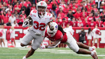 Nov 4, 2023; Piscataway, New Jersey, USA; Ohio State Buckeyes running back TreVeyon Henderson (32) runs through Rutgers Scarlet Knights defensive back Flip Dixon (10) during the second half of the NCAA football game at SHI Stadium. Ohio State won 35-16.