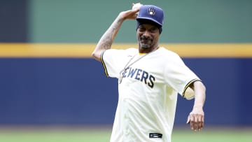 Snoop Dogg pitching at a Milwaukee Brewers game