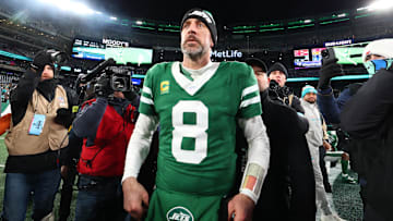 Jan 5, 2025; East Rutherford, New Jersey, USA; New York Jets quarterback Aaron Rodgers (8) walks on the field after the Jets win over the Miami Dolphins at MetLife Stadium. Mandatory Credit: Ed Mulholland-Imagn Images