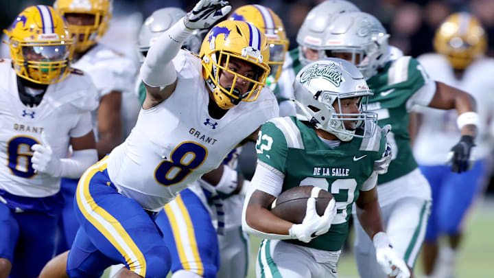 Running back Derrick Blanche (right) of De La Salle attempts to elude Grant linebacker Jeremiah Tuiileila, who had a game-high nine tackles in Friday's 42-14 DLS win.