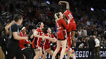 Mar 31, 2024; Portland, OR, USA; NC State Wolfpack center Lizzy Williamson (15) and guard Saniya Rivers (22) celebrate with teammates after defeating the Texas Longhorns in the finals of the Portland Regional of the NCAA Tournament at the Moda Center center. Mandatory Credit: Troy Wayrynen-Imagn Images