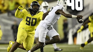 Oregon Ducks DT Jamaree Caldwell chases after Michigan State Spartans quarterback Aidan Chiles.