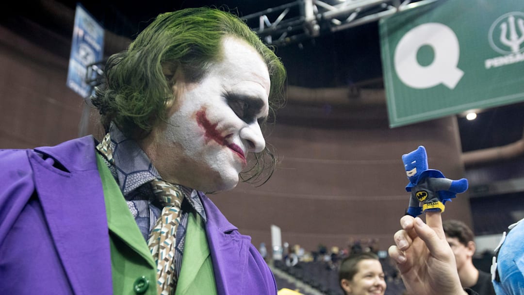 Rick Saunders, dressed as the Joker, stares down a miniature Batman on the finger of Jay Jordan during PensaCon at the Pensacola Bay Center on Friday, Feb.28, 2020.

Pensacon Friday