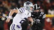 Kansas State Wildcats quarterback Avery Johnson (2) runs with the ball around Iowa State Cyclones linebacker Will McLaughlin (23) during the first quarter in the NCAA football at Jack Trice Stadium on Saturday, Nov. 30, 2024, in Ames, Iowa.