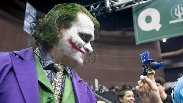 Rick Saunders, dressed as the Joker, stares down a miniature Batman on the finger of Jay Jordan during PensaCon at the Pensacola Bay Center on Friday, Feb.28, 2020.

Pensacon Friday