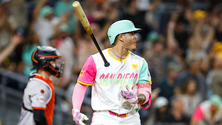 Sep 6, 2024; San Diego, California, USA; San Diego Padres third basemen Manny Machado (13) flips his bat after hitting a one run home run during the eighth inning against the San Francisco Giants at Petco Park. Mandatory Credit: David Frerker-Imagn Images