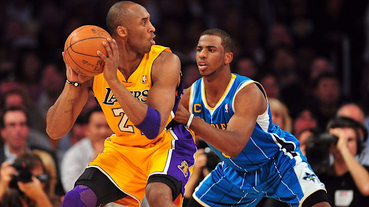 April 20, 2011; Los Angeles, CA, USA; Los Angeles Lakers shooting guard Kobe Bryant (24) moves the ball against the defense of New Orleans Hornets point guard Chris Paul (3) in the first half of game two of the first round of the 2011 NBA playoffs at the Staples Center. 