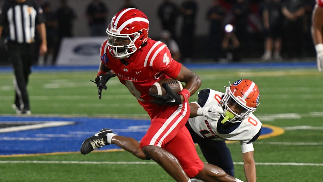 Mater Dei’s Kayden Dixon-Wyatt catches a pass and eludes a Bishop Gorman defender on Friday, September 6, 2024.