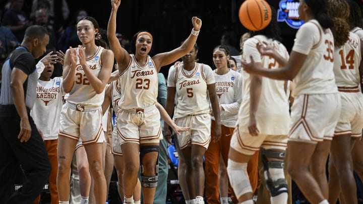 Mar 29, 2024; Portland, OR, USA; Texas Longhorns forward Aaliyah Moore (23) celebrates with teammates after a game against the Gonzaga Bulldogs in the semifinals of the Portland Regional of the 2024 NCAA Tournament at the Moda Center at the Moda Center. Mandatory Credit: Troy Wayrynen-USA TODAY Sports