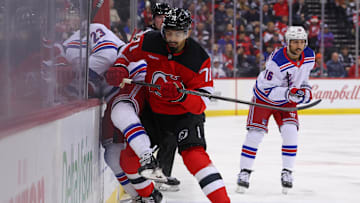 Dec 23, 2024; Newark, New Jersey, USA; New Jersey Devils defenseman Jonas Siegenthaler (71) hits New York Rangers defenseman Adam Fox (23) during the first period at Prudential Center. Mandatory Credit: Ed Mulholland-Imagn Images