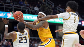 Kent State forward VonCameron Davis secures a second-half rebound between Toledo guard Tyler Cochran (23) and forward Javan Simmons (1) in the Mid-American Conference Tournament quarterfinals, Thursday, March 14, 2024, in Cleveland.