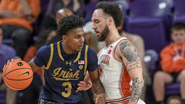 Feb 26, 2025; Clemson, South Carolina, USA; Notre Dame guard Markus Burton (3) tries to get around Clemson guard Jaeden Zachery (11) during the first half at Littlejohn Coliseum.