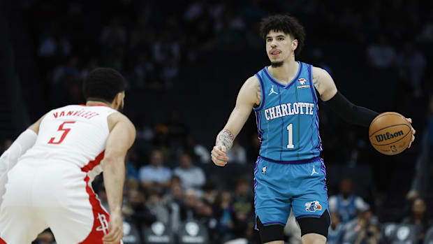 Charlotte Hornets guard LaMelo Bal brings the ball up court against Houston Rockets guard Fred VanVleet in 2023-24.