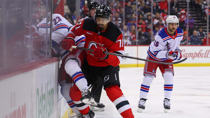 Dec 23, 2024; Newark, New Jersey, USA; New Jersey Devils defenseman Jonas Siegenthaler (71) hits New York Rangers defenseman Adam Fox (23) during the first period at Prudential Center. Mandatory Credit: Ed Mulholland-Imagn Images