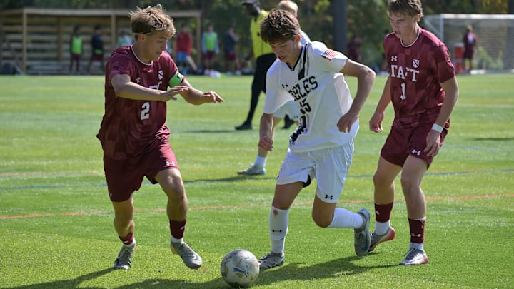 Nobles' Luke Gellert (15) works his way through Taft School defenders Sunday at the NXT LVL Showcase in Albany, N.Y.