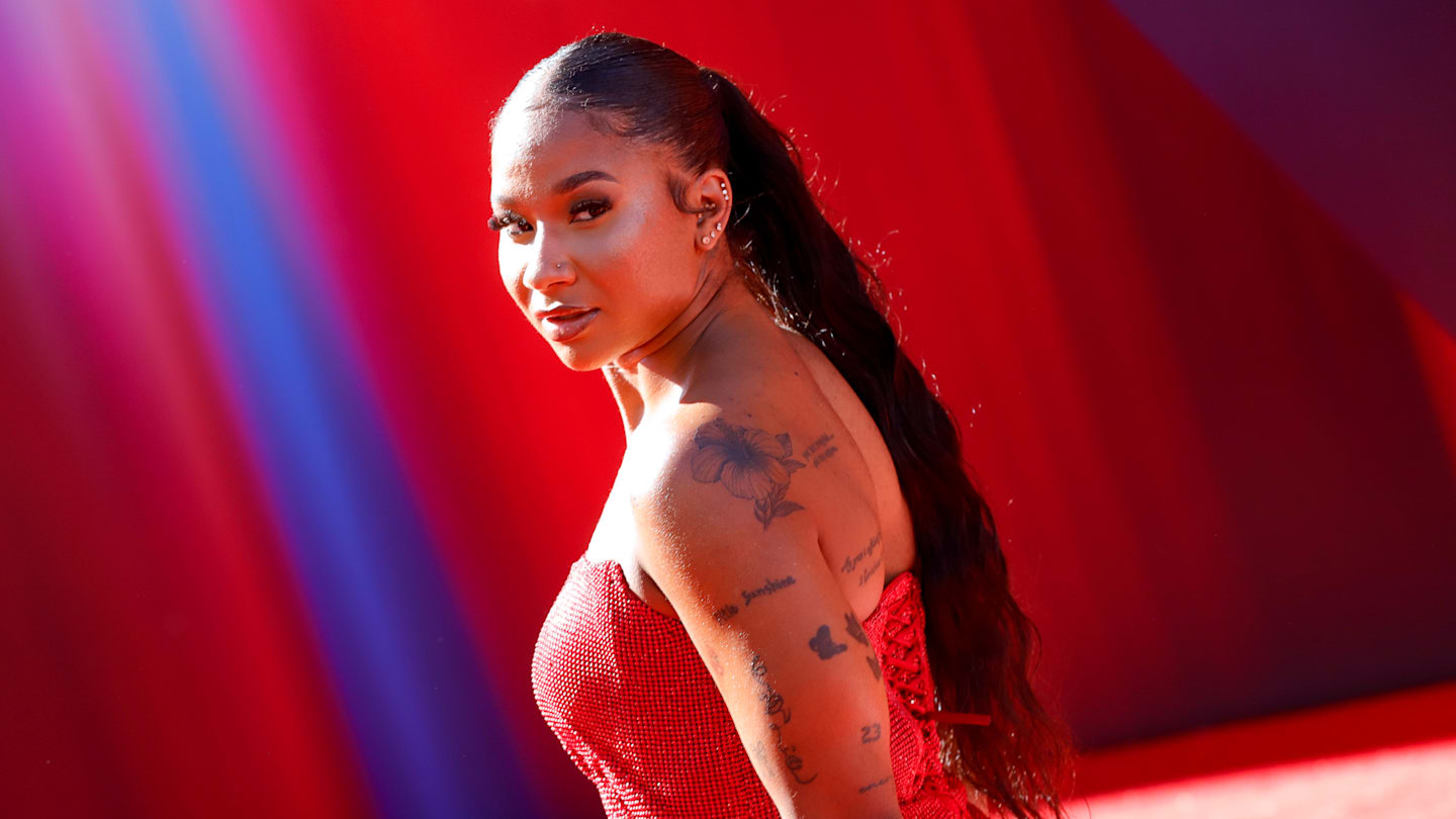 Jordan Chiles Is a Vision in Red Strapless Mini Dress for ‘Superman