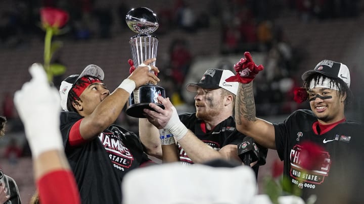 Ohio State Buckeyes quarterback C.J. Stroud (7),  linebacker Tommy Eichenberg (35) and wide receiver Jaxon Smith-Njigba (11) hoist the trophy following their 48-45 win over the Utah Utes in the Rose Bowl in Pasadena, Calif. on Jan. 1, 2022.

Rose Bowl 07