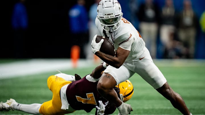 Texas Longhorns wide receiver Matthew Golden evades a tackle from Arizona State Sun Devils defensive back Shamari Simmons.