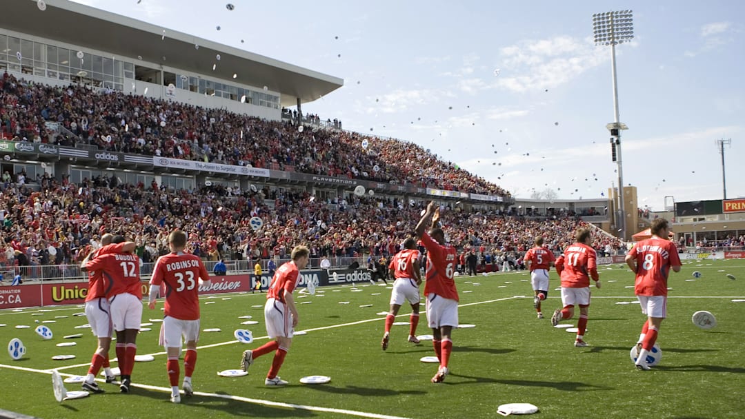 Toronto FC celebrates their first-ever goal amongst a deluge of seat cushions.
