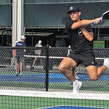 Tyler Walker from Florida Gulf Coast University jumps and hits the ball over the net during the National Collegiate Pickleball Association Tournament on Nov. 9