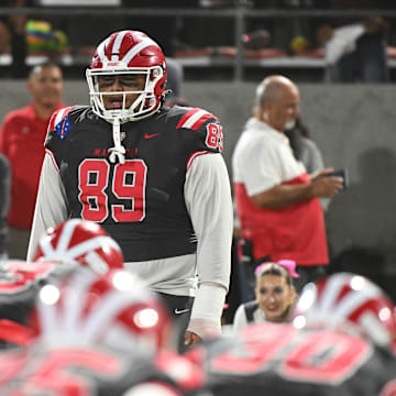 Mater Dei DL Semi Taulanga leads the Monarchs in pregame exercises before the Monarchs' 59-14 win over St. John Bosco at Santa Ana Stadium on Oct. 25, 2024.