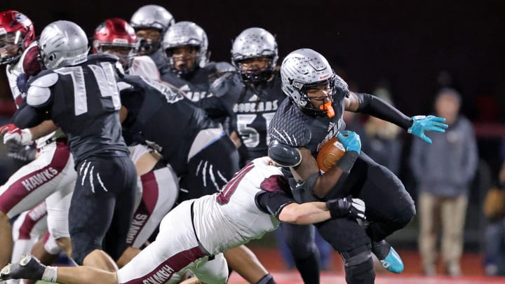 Harrisburg offensive lineman Kevin Brown (No. 74) keeps his block during a play int he 2022 PIAA Class 6A state championship game 