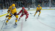 Noah Beck (2) of the Arizona State Sun Devils moves the puck near the boards, followed by Jake Fisher (19) of the Denver Pioneers and teammate, Kyle Smolen (25) during game at Mullett Arena on Feb. 8, 2025, in Tempe.