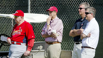 Feb 17, 2011; Jupiter, FL, USA; Watching a bullpen session from left to right is Cardinals hall of famer Red Scheondienst , chairman Bill DeWitt Jr. , minor league farm director John Vuch and VP of player development Jeff Luhnow during spring training workouts at Roger Dean Stadium. Mandatory Credit: Scott Rovak-Imagn Images