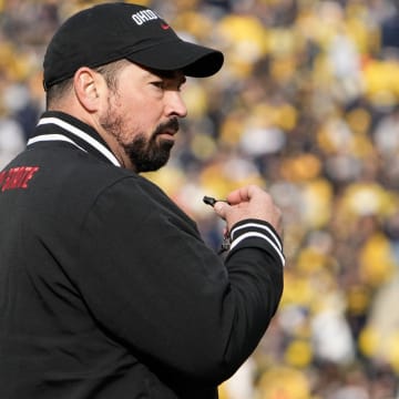 Nov 25, 2023; Ann Arbor, Michigan, USA; Ohio State Buckeyes head coach Ryan Day leads his team in warm-ups prior to the NCAA football game against the Michigan Wolverines at Michigan Stadium.