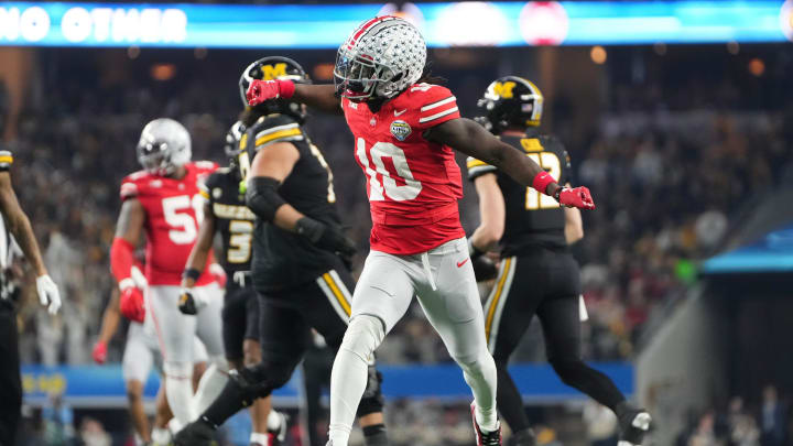 Dec 29, 2023; Arlington, Texas, USA; Ohio State Buckeyes cornerback Denzel Burke (10) celebrates a tackle during the first quarter of the Goodyear Cotton Bowl Classic against the Missouri Tigers at AT&T Stadium.