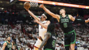 Apr 29, 2024; Miami, Florida, USA; Miami Heat guard Jaime Jaquez Jr. (11) scores in front of Boston Celtics center Kristaps Porzingis (8) during the first quarter of game four of the first round for the 2024 NBA playoffs at Kaseya Center. Mandatory Credit: Michael Laughlin-USA TODAY Sports