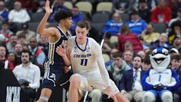 Creighton Bluejays center Ryan Kalkbrenner (11) drives against Akron Zips forward Enrique Freeman (25) during the second half of an NCAA college basketball game in the first round of the NCAA tournament at PPG Paints Arena, Thursday, March 21, 2024, in Pittsburgh, Pennsylvania.