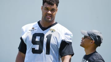 Jaguars director of football communications Dylan Morton talks with Jacksonville Jaguars defensive tackle Arik Armstead (91) at the end of the organized team activity session Monday, June 3, 2024 at EverBank StadiumÕs Miller Electric Center in Jacksonville, Fla. [Bob Self/Florida Times-Union]