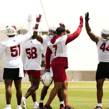 Arizona Cardinals linebacker Kyzir White (7) high-fives linebacker Owen Pappoe (44) during organized team activities in Tempe on May 20, 2024.