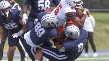 Campbell Hajj-Malik Williams in brought down on a broken play by Monmouth Miles Mitchell and Jake Brown 