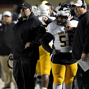 Oak Grove head coach Drew Causey (center) and his staff watch an extra point in the MHSAA Class 6A South State Championship on Friday, November 23, 2018, at Brandon High School in Brandon, Miss. 